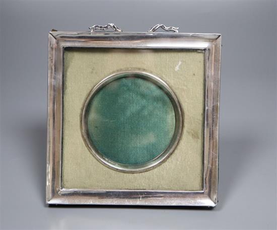 A white metal mounted photograph frame, with ribbon crest, 14cm.
